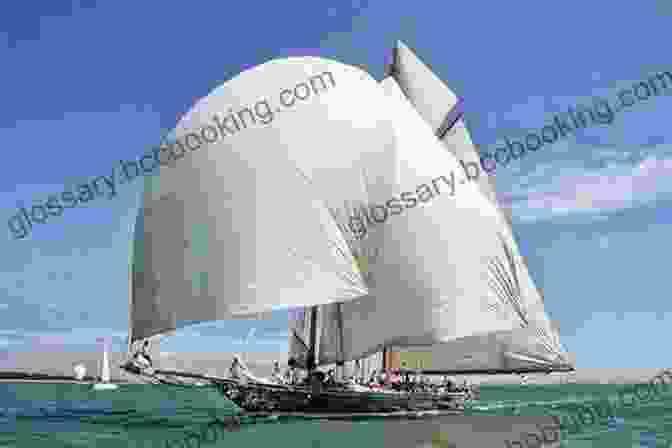 A Vibrant Sail Billowing In The Wind As An Outrigger Canoe Sails Across The Horizon. Building Outrigger Sailing Canoes: Modern Construction Methods For Three Fast Beautiful Boats